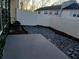 Backyard featuring a new vinyl fence, gravel landscaping, and a concrete patio at 1510 Paramount Ln, Sugar Hill, GA 30518