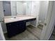 This bathroom features a large vanity with dark cabinets and modern fixtures at 1510 Paramount Ln, Sugar Hill, GA 30518