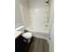 This bathroom has a shower and tub combination with a white toilet at 1510 Paramount Ln, Sugar Hill, GA 30518