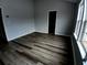 This bedroom features wood-look flooring and natural light from windows at 1510 Paramount Ln, Sugar Hill, GA 30518