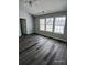 This bedroom features hardwood floors and natural light from windows at 1510 Paramount Ln, Sugar Hill, GA 30518