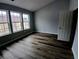 Bright bedroom with modern flooring and natural light from three large windows at 1510 Paramount Ln, Sugar Hill, GA 30518