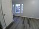 Bedroom with gray wood-look floors, natural light and a closet at 1510 Paramount Ln, Sugar Hill, GA 30518