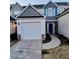 Inviting home with a garage, stone accents, neutral siding, and blue shutters creating a charming curb appeal at 1510 Paramount Ln, Sugar Hill, GA 30518
