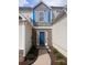 Charming home featuring a blue front door, stone accents, and light-colored siding, creating a welcoming entrance at 1510 Paramount Ln, Sugar Hill, GA 30518