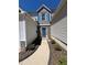 Home featuring stone accents, blue door and shutters and manicured landscaping at 1510 Paramount Ln, Sugar Hill, GA 30518