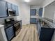 New stainless steel appliances, blue cabinets, and plenty of countertop space make this kitchen a dream at 1510 Paramount Ln, Sugar Hill, GA 30518