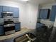 This kitchen features stainless steel appliances, beautiful counters, and laminate flooring at 1510 Paramount Ln, Sugar Hill, GA 30518