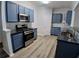 Modern kitchen features stainless steel appliances, blue cabinets, and subway tile backsplash at 1510 Paramount Ln, Sugar Hill, GA 30518