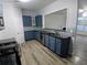 Modern kitchen boasts sleek countertops, stainless steel appliances, and stylish blue cabinetry at 1510 Paramount Ln, Sugar Hill, GA 30518