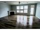 Bright living room with a fireplace and large windows, complete with modern flooring at 1510 Paramount Ln, Sugar Hill, GA 30518