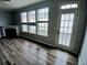A bright living room boasts hardwood floors, fireplace, and windows at 1510 Paramount Ln, Sugar Hill, GA 30518