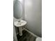 A powder room features a pedestal sink and streamlined toilet at 1510 Paramount Ln, Sugar Hill, GA 30518