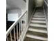 Staircase with hardwood steps and white risers, white banister and white spindles at 1510 Paramount Ln, Sugar Hill, GA 30518