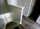 Staircase featuring carpet steps, wood-look floors, and neutral walls at 1510 Paramount Ln, Sugar Hill, GA 30518