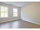 Bright bedroom featuring wood-look flooring, two windows and neutral walls at 205 Admor Ln, Acworth, GA 30102