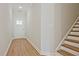 Entryway with hardwood floors, white walls, stairs with wood treads and a white front door with glass pane at 205 Admor Ln, Acworth, GA 30102