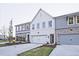 Newly constructed townhomes with a mix of painted brick and siding exteriors, complemented by well-maintained lawns at 205 Admor Ln, Acworth, GA 30102