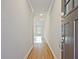 Bright hallway with hardwood floors and recessed lighting leading to a sunlit room, showcasing modern home design at 205 Admor Ln, Acworth, GA 30102