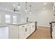Modern kitchen island with granite countertops, stainless steel appliances, and stylish pendant lighting at 205 Admor Ln, Acworth, GA 30102