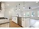 Kitchen with stainless steel appliances, granite countertop island and pendant lights adjacent to living area at 205 Admor Ln, Acworth, GA 30102