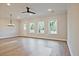 Spacious living room featuring hardwood floors, large windows offering natural light, and modern ceiling fan at 205 Admor Ln, Acworth, GA 30102