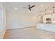 Bright, open-concept living space featuring modern lighting, ceiling fan, and a view into the kitchen at 205 Admor Ln, Acworth, GA 30102