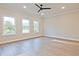 Sun-drenched living area with beautiful windows and a contemporary ceiling fan at 205 Admor Ln, Acworth, GA 30102