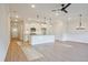 Open-concept living space combining a modern kitchen with a large island and a well-lit living area at 205 Admor Ln, Acworth, GA 30102