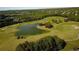 Aerial view of beautiful golf course with green fairways and a serene pond at 3060 Salisbury Ln, Cumming, GA 30041