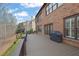 Brick home with large deck overlooking a landscaped yard with trees and nice view on a sunny day at 3060 Salisbury Ln, Cumming, GA 30041