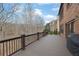 Backyard with wooden deck and lush greenery, showcasing trees, lawn, and a serene outdoor space at 3060 Salisbury Ln, Cumming, GA 30041