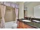 Bathroom with a granite countertop vanity, and a shower-tub combo with tiled walls at 3060 Salisbury Ln, Cumming, GA 30041