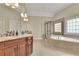 Luxurious bathroom with double vanity, granite countertops, a soaking tub, and a separate glass-enclosed shower at 3060 Salisbury Ln, Cumming, GA 30041