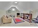 Comfortable bonus room includes seating, bookshelves, and a cozy atmosphere at 3060 Salisbury Ln, Cumming, GA 30041