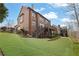 View of a brick home's backyard with a multilevel deck and well-manicured lawn at 3060 Salisbury Ln, Cumming, GA 30041
