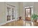 Inviting foyer with hardwood floors, a wooden front door, and French doors leading to another room at 3060 Salisbury Ln, Cumming, GA 30041