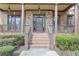 Elegant front entrance with stone accents, a covered porch, and a brick stairway leading to the door at 3060 Salisbury Ln, Cumming, GA 30041