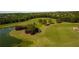 Scenic aerial view of the community's golf course, showcasing lush green fairways, mature trees, and a serene pond at 3060 Salisbury Ln, Cumming, GA 30041