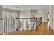 Well-lit hallway featuring wood floors, an iron banister and a view of the living area below at 3060 Salisbury Ln, Cumming, GA 30041