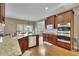Gourmet kitchen showcasing granite counters, stainless appliances, custom cabinets and an island with a sink at 3060 Salisbury Ln, Cumming, GA 30041