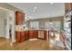 A modern kitchen featuring wooden cabinets, stainless steel appliances, and an adjacent dining area for casual meals at 3060 Salisbury Ln, Cumming, GA 30041