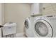 Functional laundry room with modern appliances, a utility sink, and built-in storage shelves at 3060 Salisbury Ln, Cumming, GA 30041