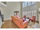 Open-concept living room with large windows, plantation shutters, fireplace, and a comfortable seating arrangement at 3060 Salisbury Ln, Cumming, GA 30041