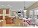 Open-concept kitchen and living room with hardwood floors, a fireplace, and access to the back deck at 3060 Salisbury Ln, Cumming, GA 30041