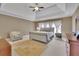 Spacious main bedroom with tray ceiling, soft natural light, and a comfortable seating area at 3060 Salisbury Ln, Cumming, GA 30041