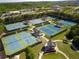 Aerial view of community tennis courts surrounded by lush landscaping at 3060 Salisbury Ln, Cumming, GA 30041
