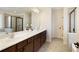 Large bathroom featuring double sinks, framed mirror, walk-in shower and soaking tub at 6125 Allison Rd, Cumming, GA 30040