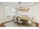 Bright dining room with a wooden table, stylish chairs, and modern light fixture at 6125 Allison Rd, Cumming, GA 30040