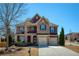 Charming two-story brick home with a well-manicured lawn, two car garage and stone accents at 6125 Allison Rd, Cumming, GA 30040